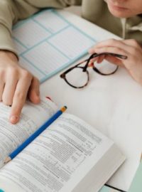 Estudante com livro na mesa estudando