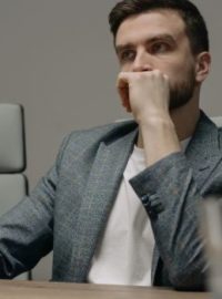 Homem sentado na mesa pensando